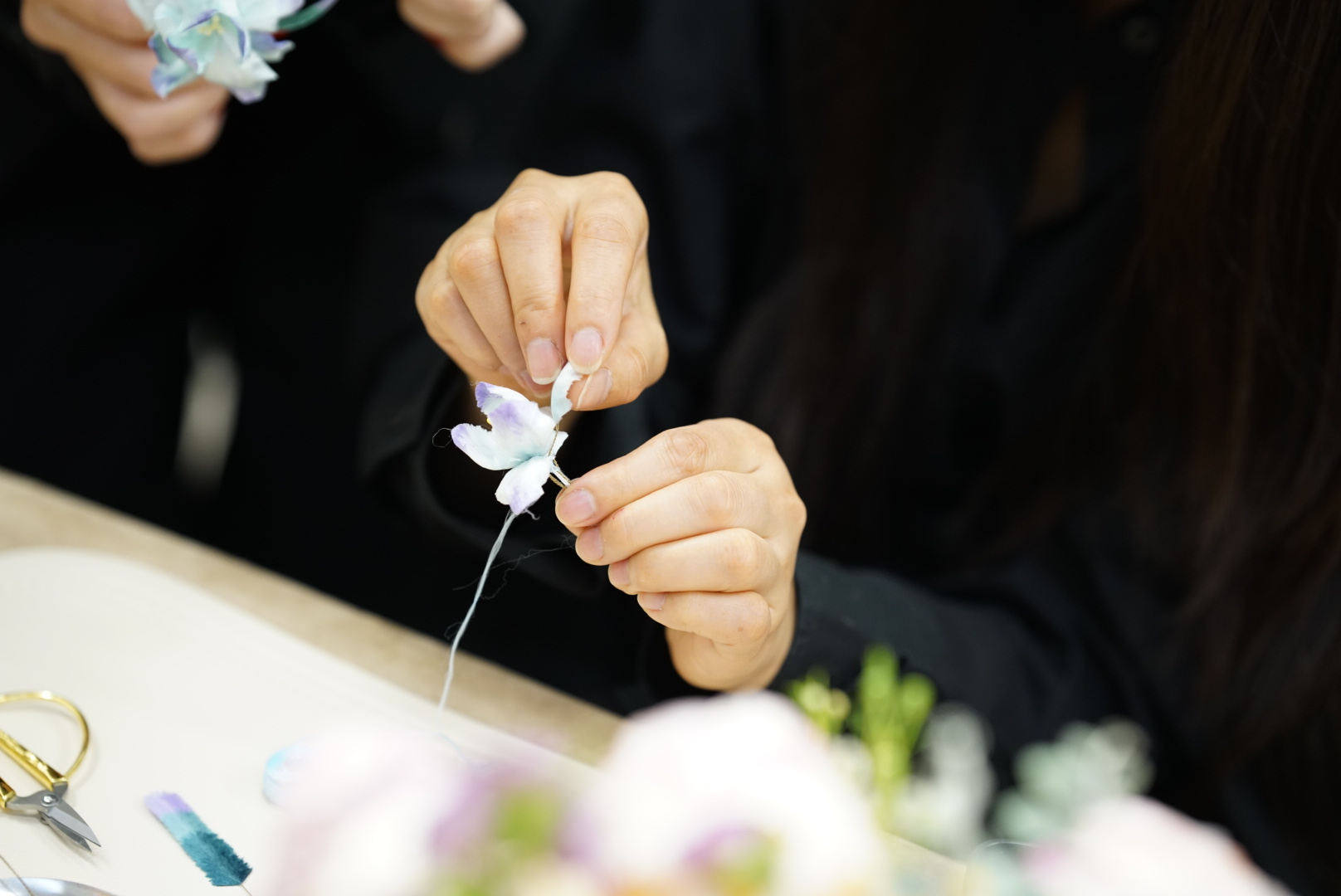 Hands crafting ronghua flower